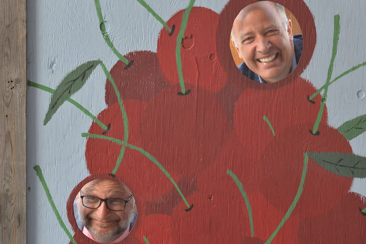 Justice Minister David Lametti and Kelowna-Lake Country MP Stephen Fuhr pose for a cherry candid at Hillcrest Farm on Aug. 13, following a federal investment announcement. (David Venn - Kelowna Capital News)
