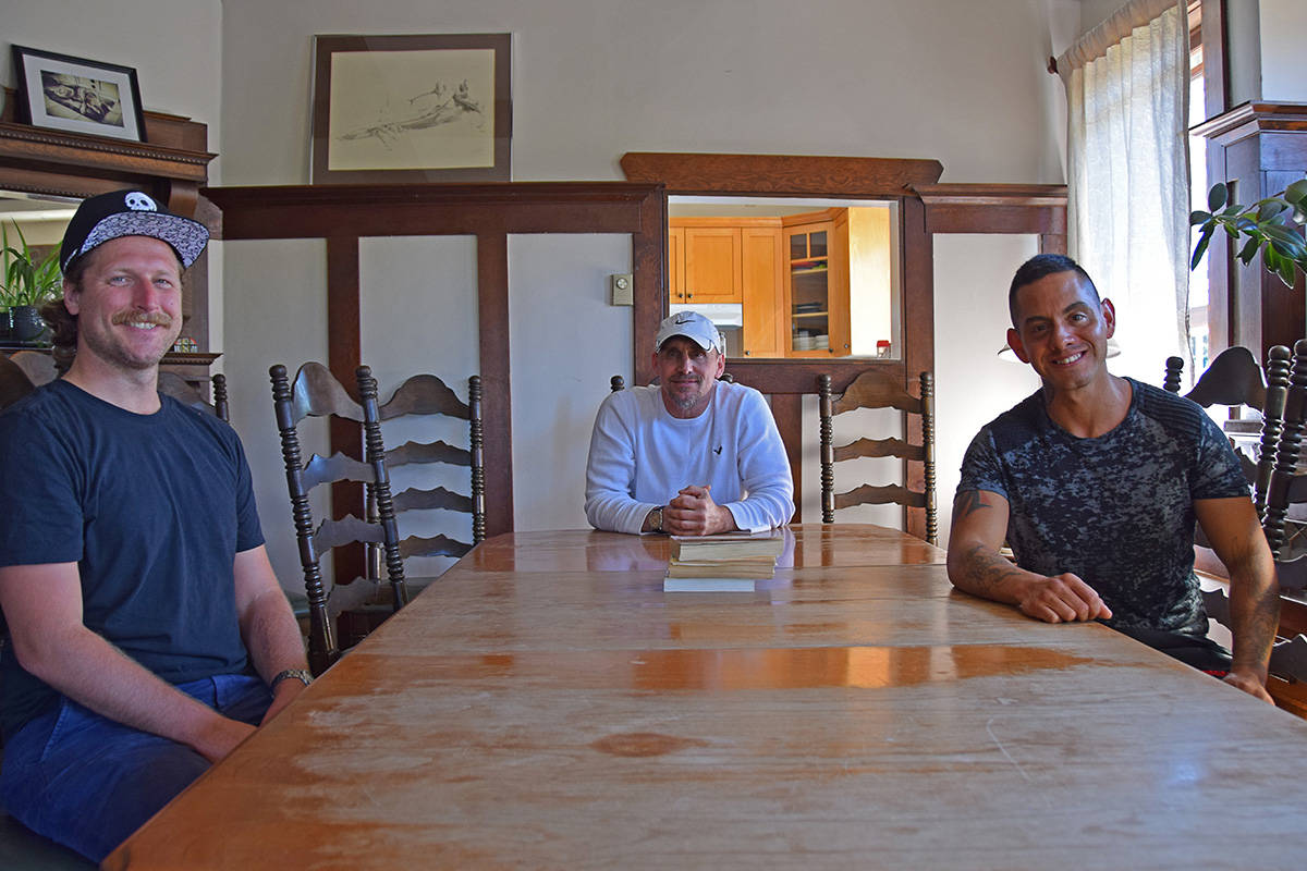 Scott Shepard, Rick Storey and Adrian Maxwell at the dining table in Foundation House, one of three recovery homes run by Umbrella Society for people dealing with substance abuse issues. (Kendra Crighton/News Staff)