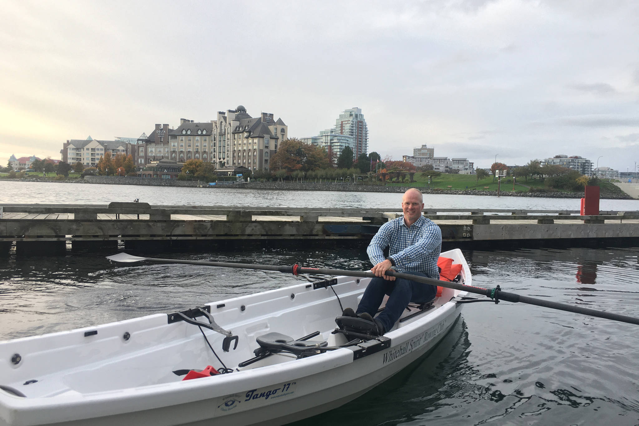 Former Olympian Adam Kreek sits in the boat he offered to row climate activist Greta Thunberg to Vancouver Island in Victoria Harbour. (Sophie Heizer/News Staff)