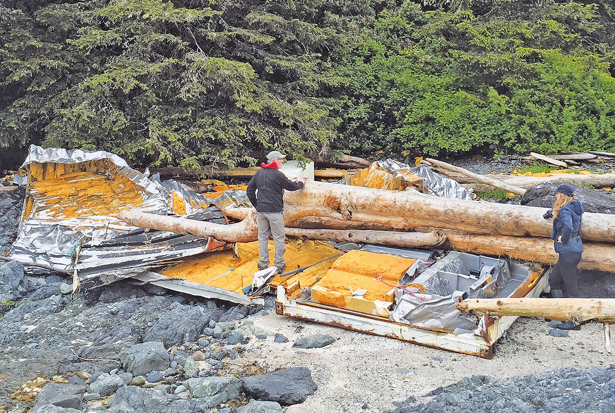 Parks Canada staffer Pete Clarkson and Surfrider beach clean coordinator Sarah Greenwood check out a broken up shipping container that crashed on the George Fraser Islands. (Photo - Alan Hall)