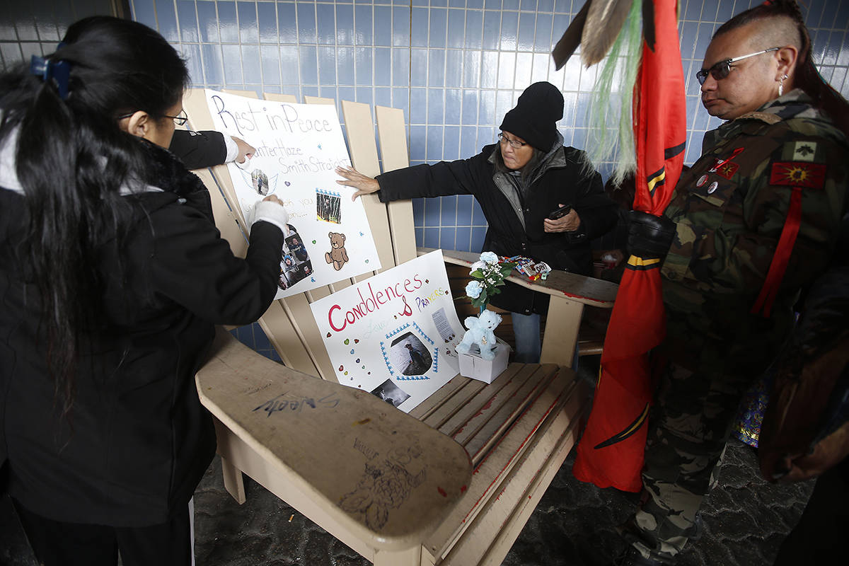 Women put up posters of Hunter Haze Straight-Smith, the three-year-old who was allegedly stabbed by his mother’s boyfriend and taken off life support today, at a vigil outside Winnipeg’s Childrens Hospital, Friday, November 1, 2019. THE CANADIAN PRESS/John Woods