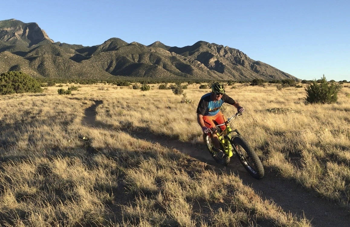 This July 8, 2019 image shows a mountain biker riding the singletrack trail on national forest land in Placitas, New Mexico. Officials say the outdoor recreation industry already brings billions of dollars to the state’s coffers but there’s room to grow. (AP Photo/Susan Montoya Bryan)