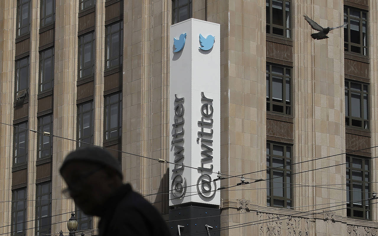 FILE - In this July 9, 2019, file photo a pedestrian walks across the street from the Twitter office building in San Francisco. A complaint unsealed in a federal court detailed a coordinated effort by Saudi officials to recruit employees at the social media giant who could tap into the Twitter accounts of political opponents and access their personal data, including internet protocol addresses that can give up a user’s location. (AP Photo/Jeff Chiu, File)