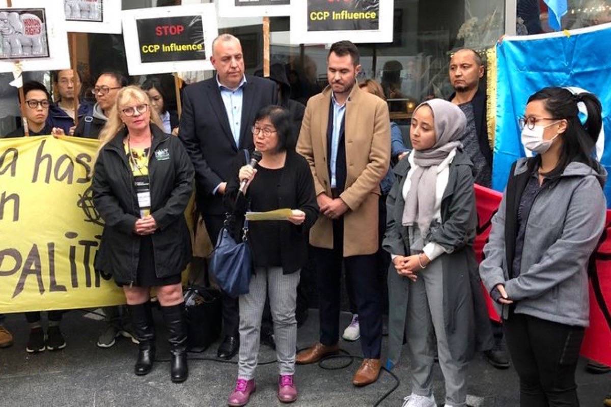 Fenella Sung of Canadian Friends of Hong Kong speaks to a protest rally outside the Union of B.C. Municipalities convention, Vancouver, Sept. 25, 2019. Behind her is Port Coquitlam Mayor Brad West (brown coat) and Coun. Steve Darling. (Katya Slepian/Black Press)