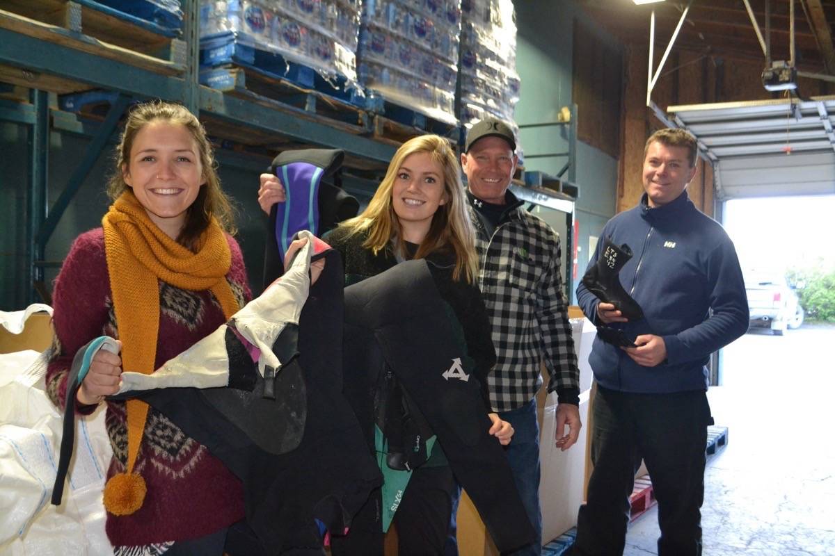 Surfrider Pacific Rim’s youth co-ordinator Alys Hoyland, left, and chapter manager Lilly Woodbury pack up the last of the worn out wetsuits with Far West Distributors team Scott Johnson and John De Vries on Nov.27. (Nora O’Malley / Westerly News)
