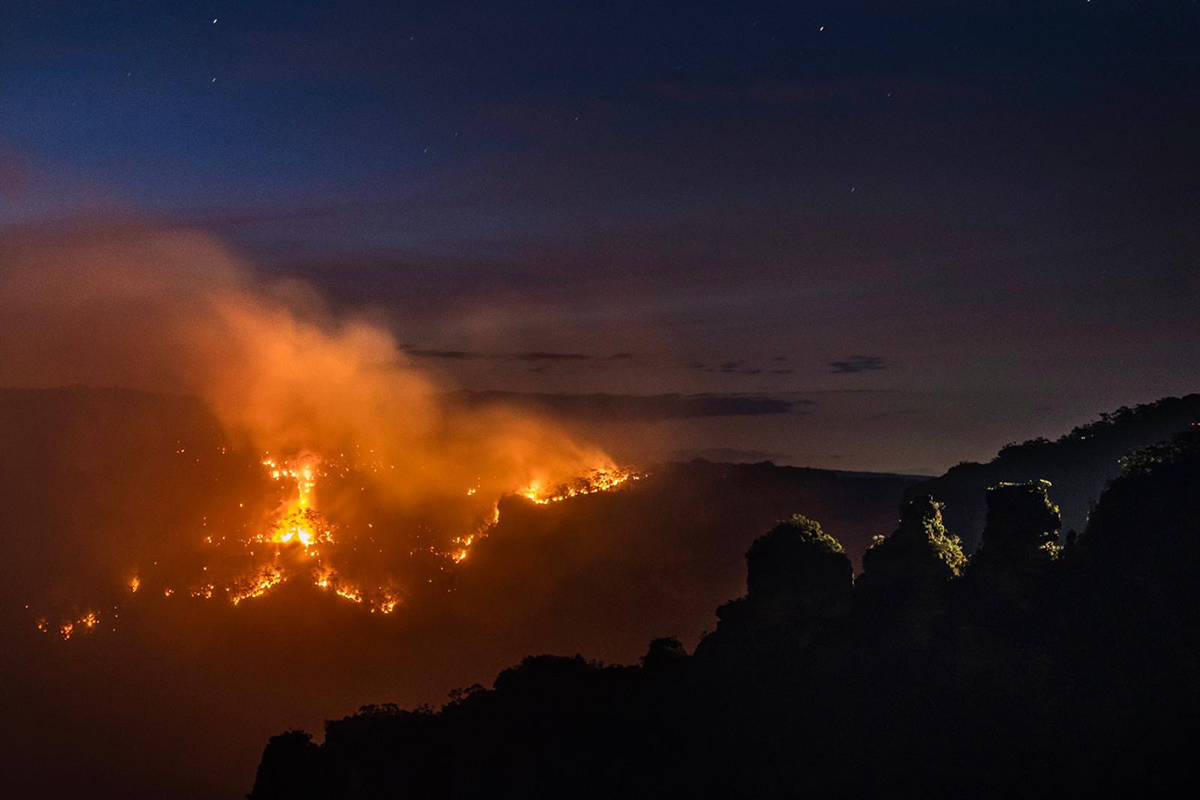 More than 1,750 firefighters and support crew worked overnight on Monday to slow the spread of fire across New South Wales. (Wolter Peters photo/NSW Rural Fire Service)