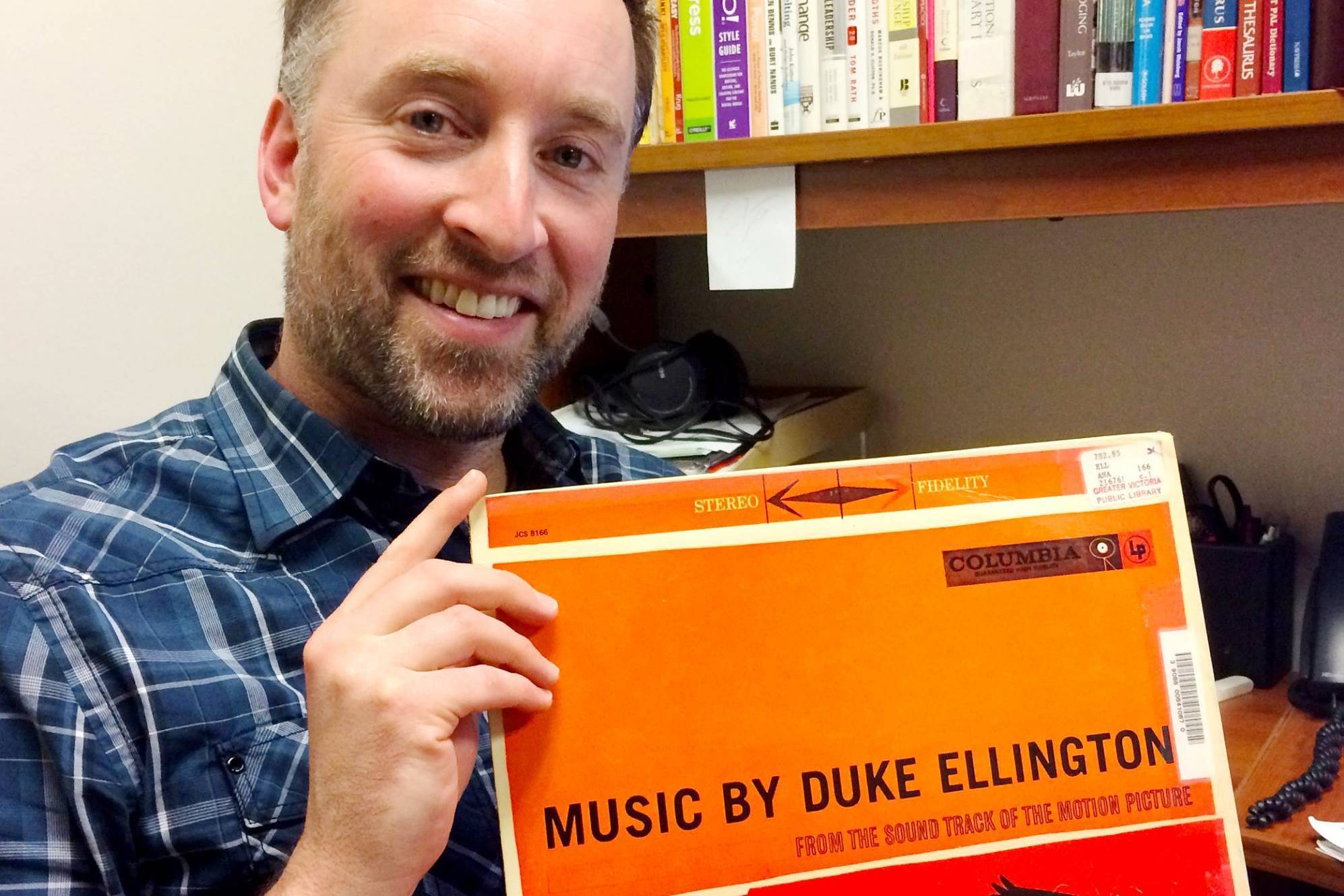 Senior librarian Matthew Bingham holds up the infamous LP soundtrack that was returned to the GVPL in December 2017. (Photo courtesy Jessica Woollard)
