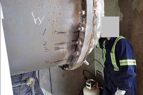 The opposite side of the chiller flange shows numbered locations where cracks were discovered. Workers’ faces have been intentionally greyed out as part of Technical Safety BC’s final report. (PHOTO COURTESY TSBC)