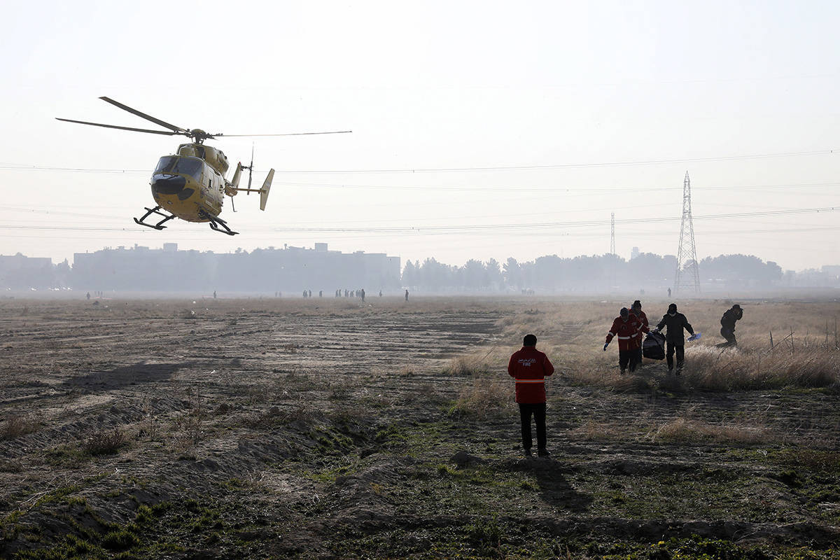 Rescue team work at the scene where an Ukrainian plane crashed in Shahedshahr, southwest of the capital Tehran, Iran, Wednesday, Jan. 8, 2020. A Ukrainian airplane carrying 176 people crashed on Wednesday shortly after takeoff from Tehran’s main airport, killing all onboard. (AP Photo/Ebrahim Noroozi)