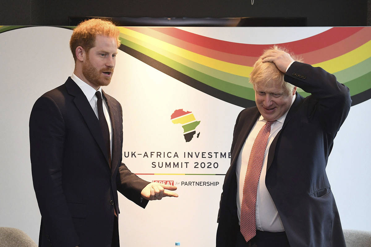 Britain’s Prince Harry and Prime Minister Boris Johnson, right, at the UK Africa Investment Summit in London, Monday Jan. 20, 2020. Boris Johnson is hosting 54 African heads of state or government in London. The move comes as the U.K. prepares for post-Brexit dealings with the world. (Stefan Rousseau/Pool via AP)