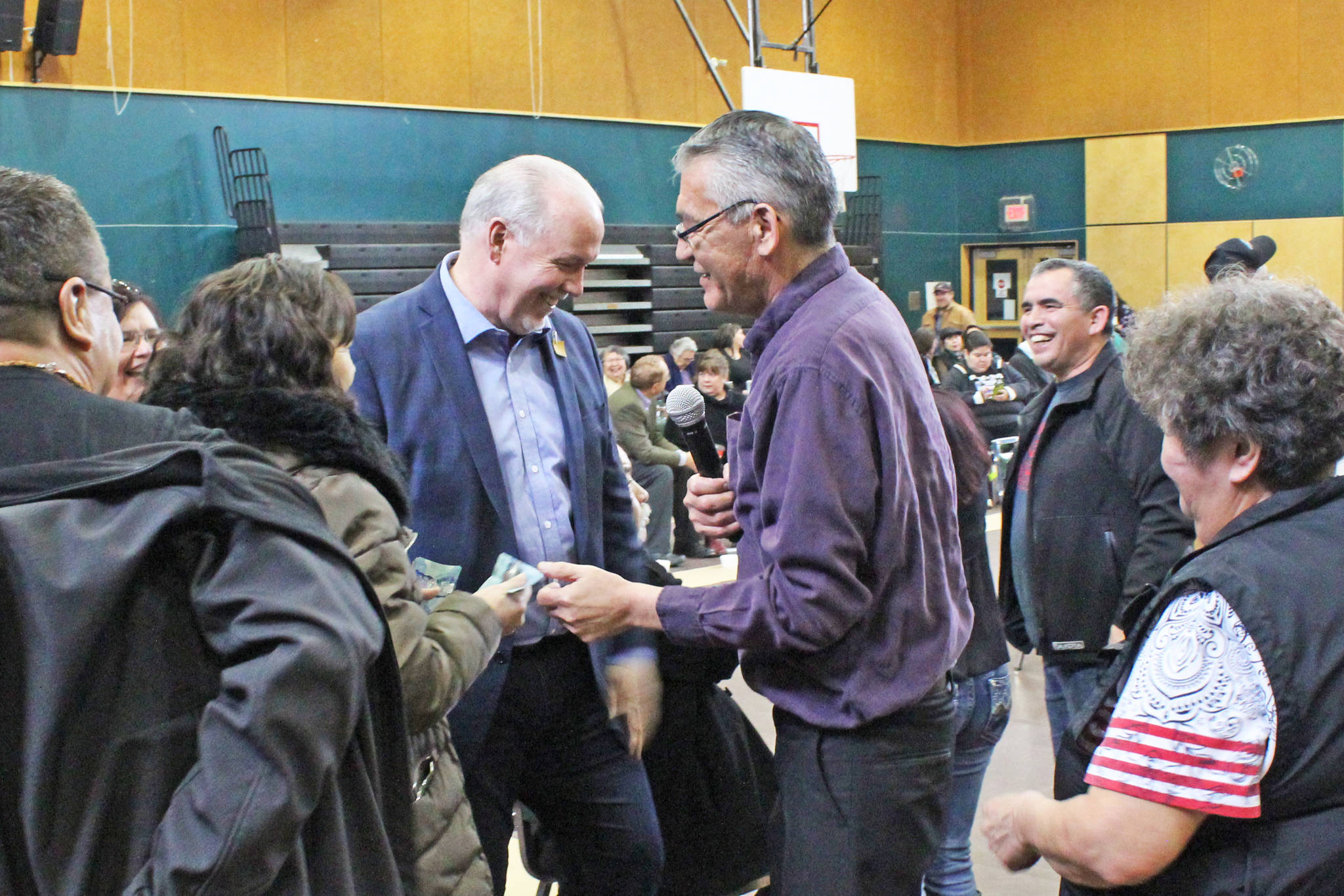 Premier John Horgan, left, shares a laugh with with Chief Na’Moks (John Ridsdale) during a smoke feast in Witset March 16 held to announce a new round of discussions on Indigenous rights and title between the Wet’suwet’en and Province of British Columbia. (Thom Barker photo)