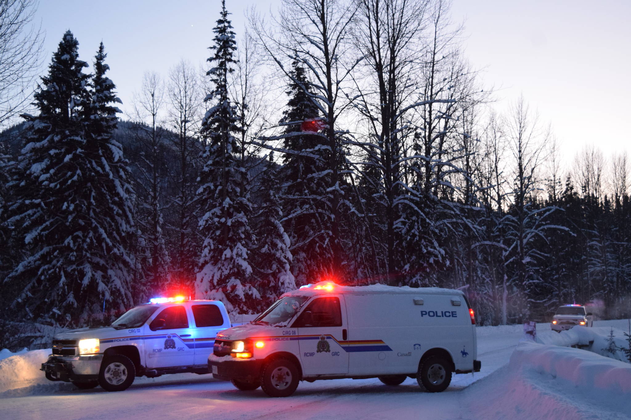 RCMP vehicles pictured at the 27-kilometre mark of Morice West Forest Service Road. The RCMP has said they have set up the check point to assure safety and mitigate concerns surrounding a number of hazardous items found in close proximity to a number of felled logs further down the road. (Trevor Hewitt photo)