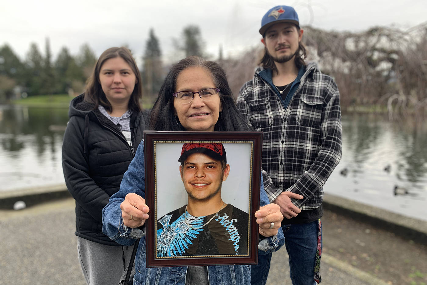 Flanked by her daughter Sarah and eldest son Jared, Maggie Smith holds a photograph of her son Tim Postma who died on the streets of Chilliwack on Jan. 22, 2020. (Paul Henderson/ The Progress)