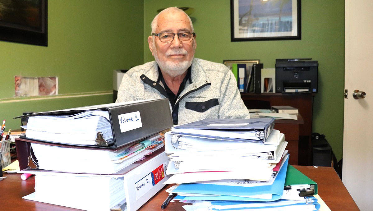Julio Godoy shows just a portion of the legal papers he’s filed in his fight to get access to a reliable water supply at his Seed Tree Road home. Water is a major concern for many Sooke Region residents. (Tim Collins - Black Press Media)