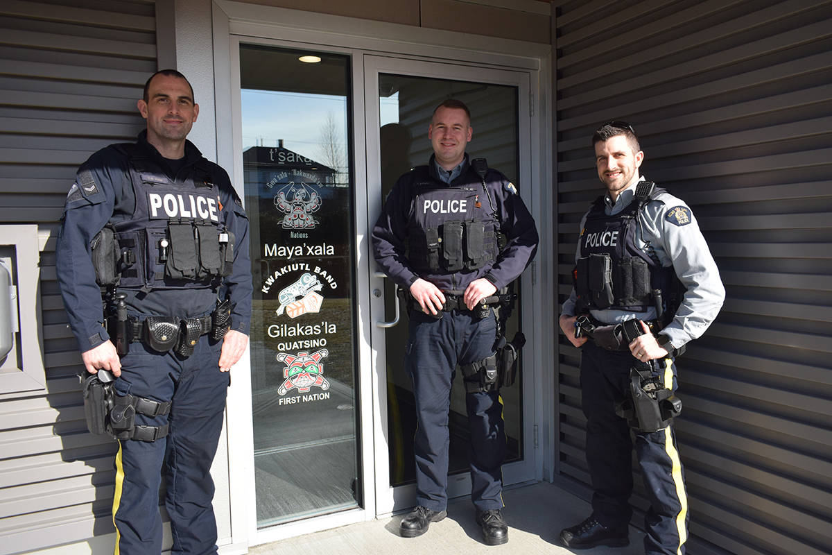 Corp. Chris Voller, Cst. Jordan Mullen and Cst. Jason Tymofichuk stand proudly next to the newly printed North Island Indigenous First Nation symbols and Kwak’wala language at the Port Hardy RCMP station. (Tyson Whitney - North Island Gazette)