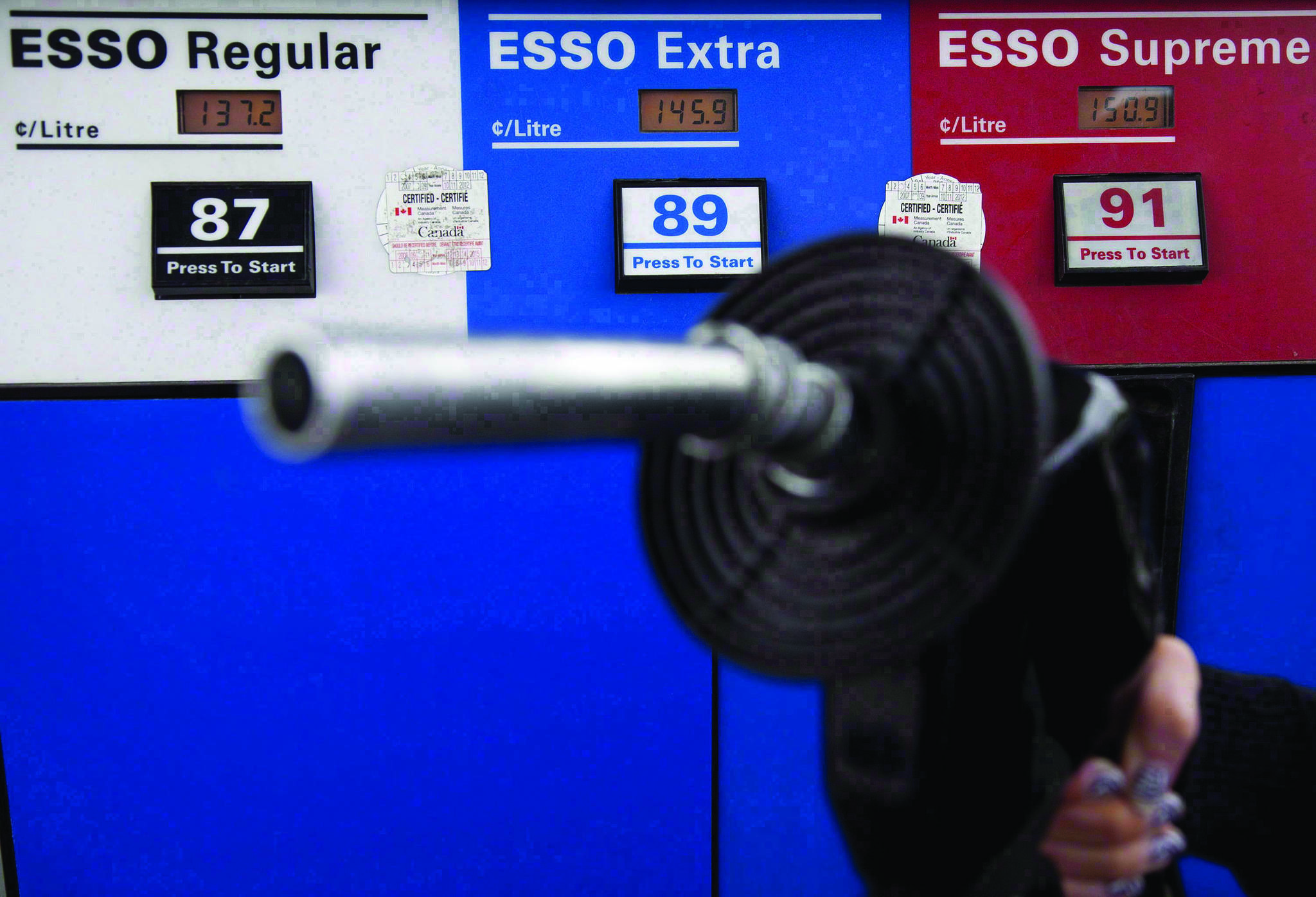 Gas prices are displayed as a motorist prepares to pump gas at a station in North Vancouver, B.C., Tuesday, May 10, 2011. THE CANADIAN PRESS/Jonathan Hayward