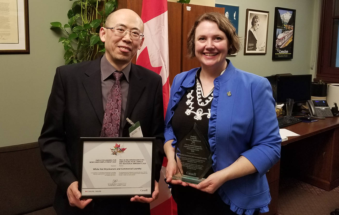 White Hat Drycleaners owner Ai Guo Zhang has been recognized by the federal government for his dedication to hiring newcomers to Canada and supporting them as they get settled in the community. Photo Submitted