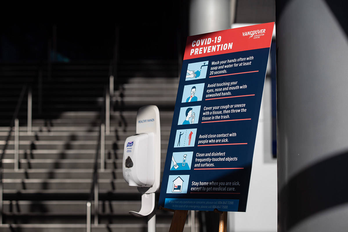 A hand sanitizer dispenser and a sign indicating steps to be taken to limit the spread of the novel coronavirus COVID-19 is seen at an entrance to the Vancouver Convention Centre, in Vancouver, on Saturday, March 14, 2020. THE CANADIAN PRESS/Darryl Dyck