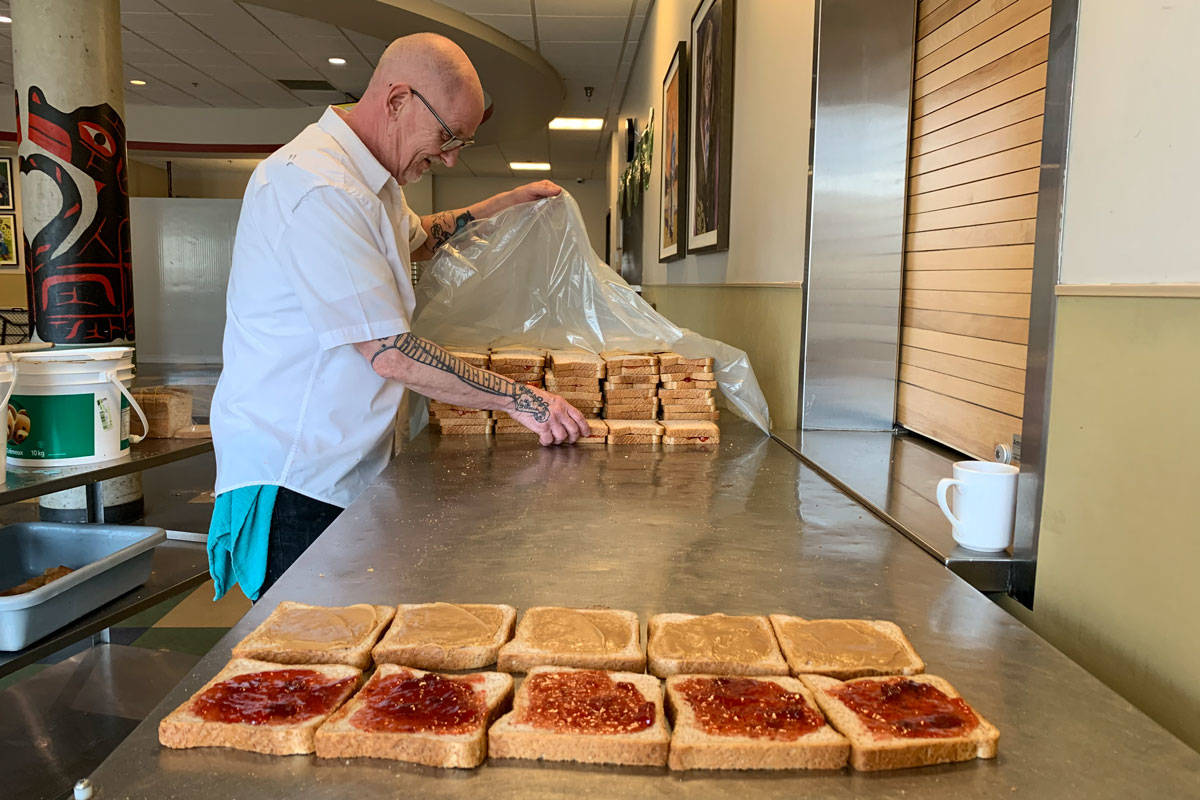 Sandwiches are made for the homeless as Our Place closes its drop-in amidst COVID-19. All meals will now be served outside of 919 Pandora Ave. (Courtesy of Grant McKenzie/Our Place)
