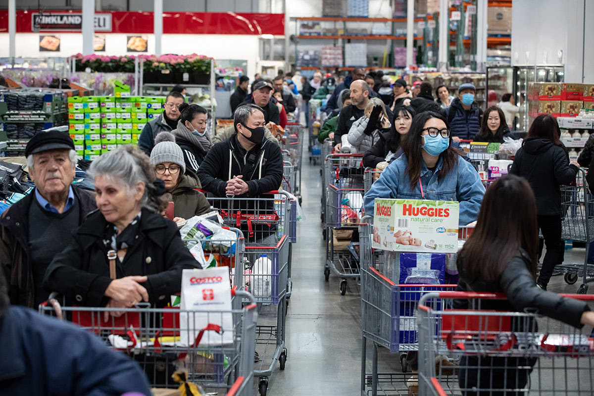 Some of the hundreds of people queued in multiple lines wait to pay for their purchases at a Costco store, amid concerns about the spread of the coronavirus, in Burnaby, B.C., on Monday, March 16, 2020. Prime Minister Justin Trudeau has announced the closure of Canada’s border to those who aren’t Canadian citizens or permanent residents to slow the spread of COVID-19. THE CANADIAN PRESS/Darryl Dyck
