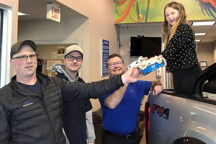 Vernon Girl Guide Mabel Smith sells cookies to staff at Watkin Motors Ford prior to the suspension of sales. (Facebook Photo)