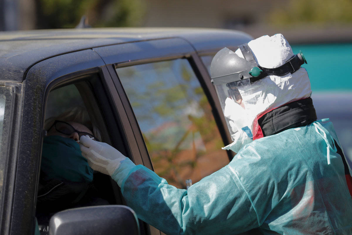 A driver gets tested for COVID-19 at a drive-through point in Zagreb, Croatia, Wednesday, April 1, 2020. (AP Photo/Darko Bandic)