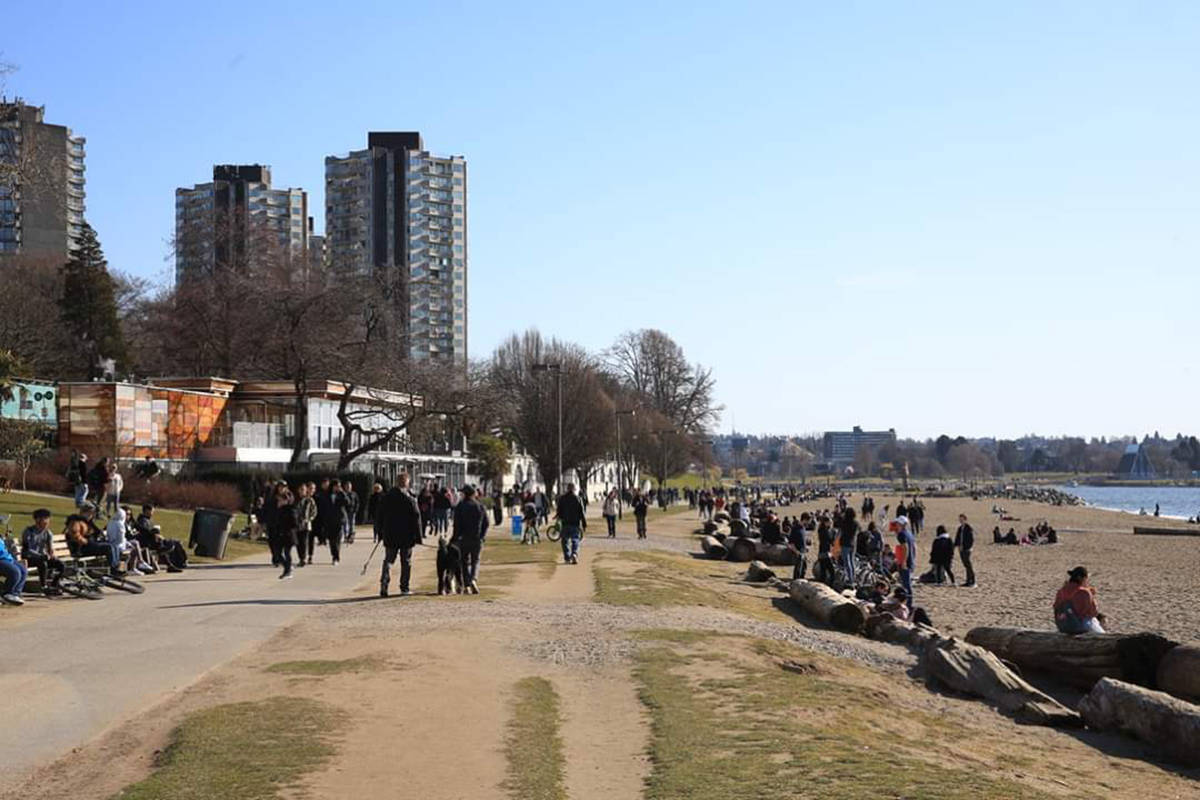 People spend a day in the sun at Vancouver’s English Bay in March. Bylaw officers, park rangers and police are working out how to keep the public educated about physical distancing. Photo: Gerry Green/Twitter