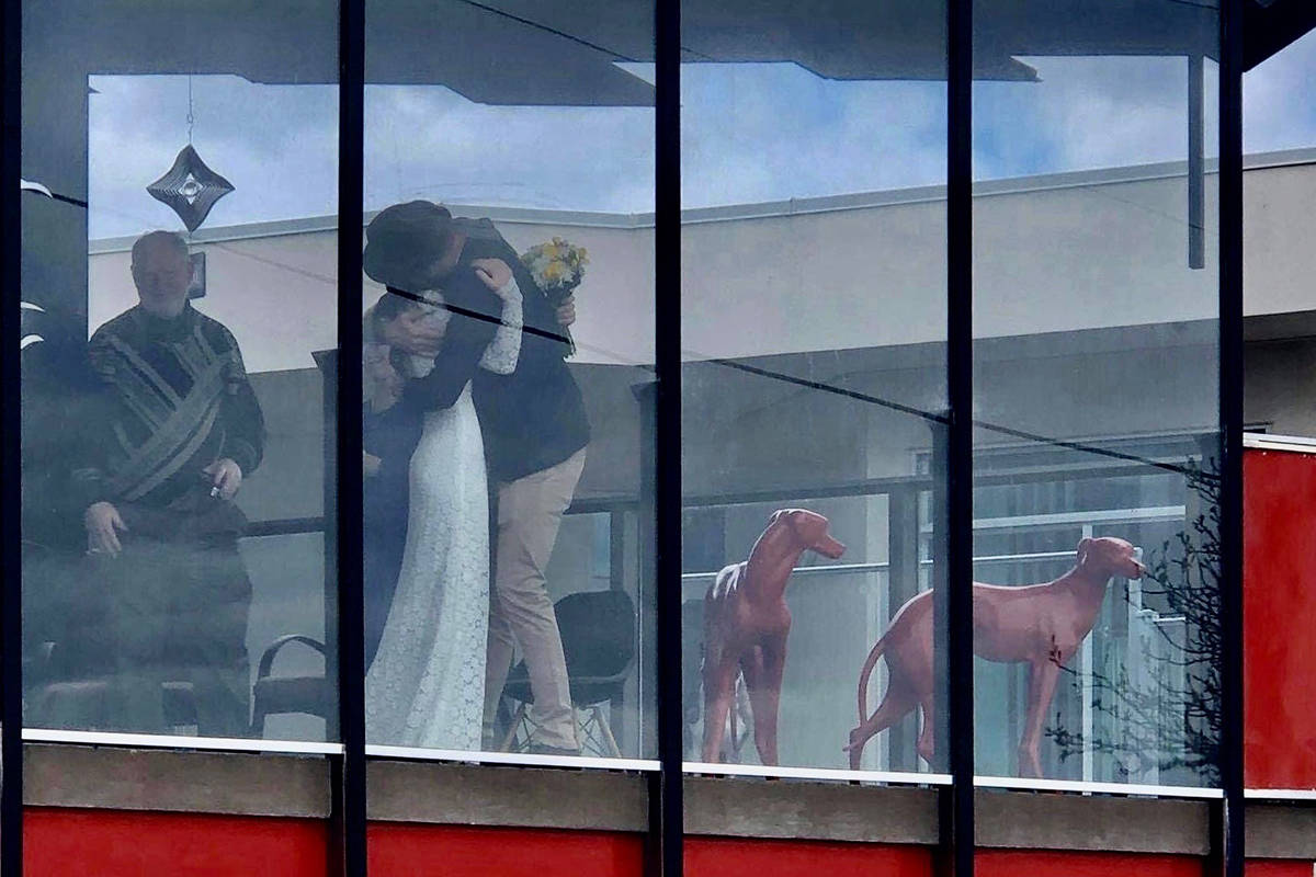 Scott Stanton and Salina Hoffman tied the knot on Saturday and were surprised by friends and family who had gathered outside to watch the ceremony from a distance. (Provided by Scott Stanton)