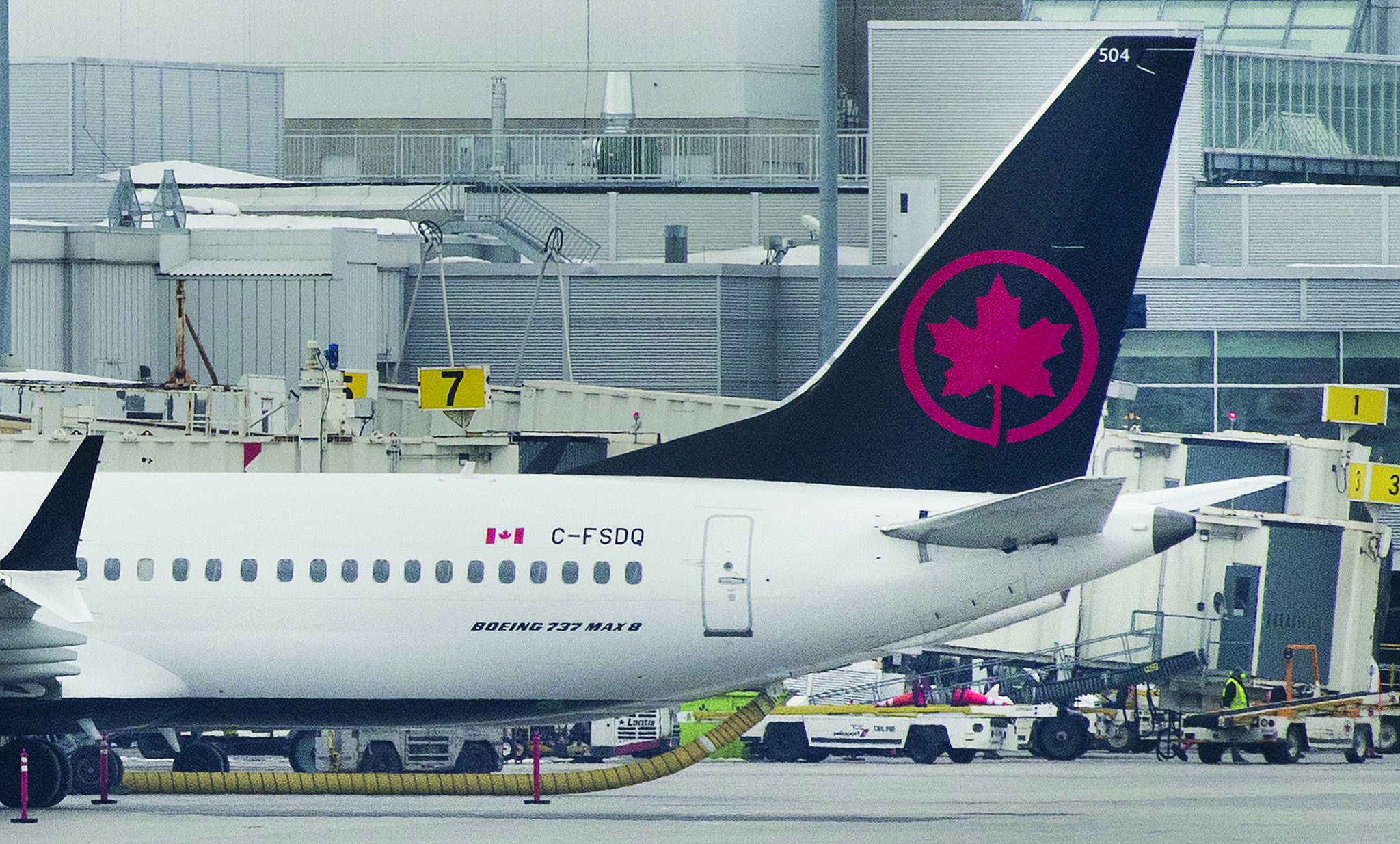 FILE – An Air Canada Boeing 737 Max 8 aircraft is shown next to a gate at Trudeau Airport in Montreal on March 13, 2019. THE CANADIAN PRESS/Graham Hughes