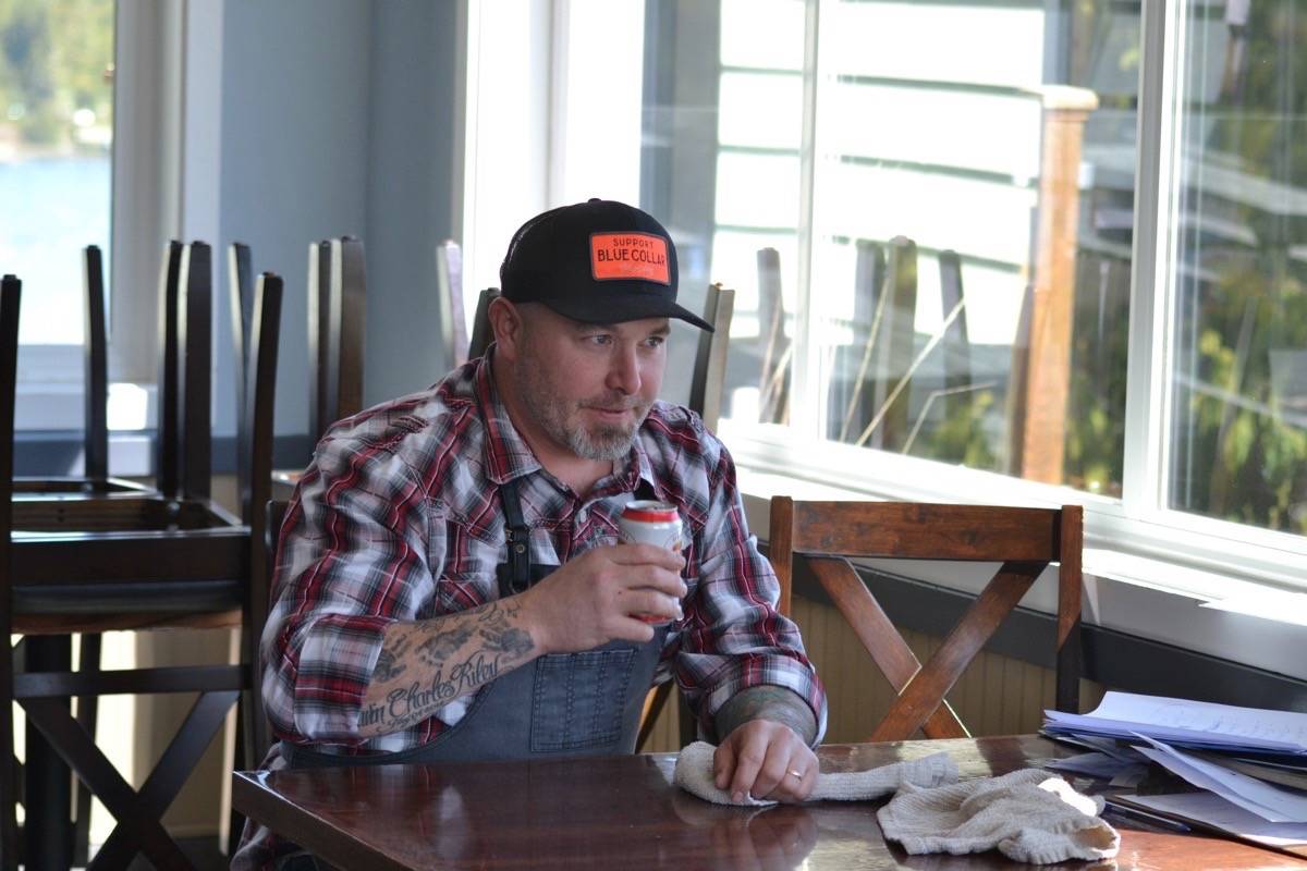 Chef Dustin Riley nurses a cold can of Lucky Lager in his empty Ucluelet restaurant ‘The Blue Room’ over Easter long weekend. (Nora O’Malley photo)