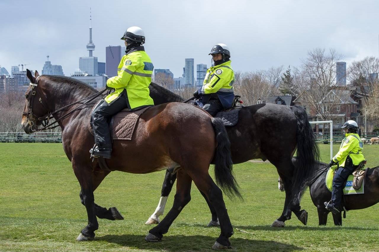 Toronto Police Mounted Unit officers patrol a city park in Toronto on Thursday, April 16, 2020. The Canadian Civil Liberties Association says it’s going to seek amnesty for all tickets issued for municipal recreational infractions during the COVID-19 pandemic. THE CANADIAN PRESS/Frank Gunn