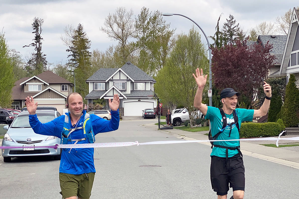 Duncan Magnus (left) and Douglas Delipper crossed the finish line at the end of their at-home version of the Boston Marathon on Sunday April 19th in their Willoughby neighbourhood. special to Langley Advance Times)