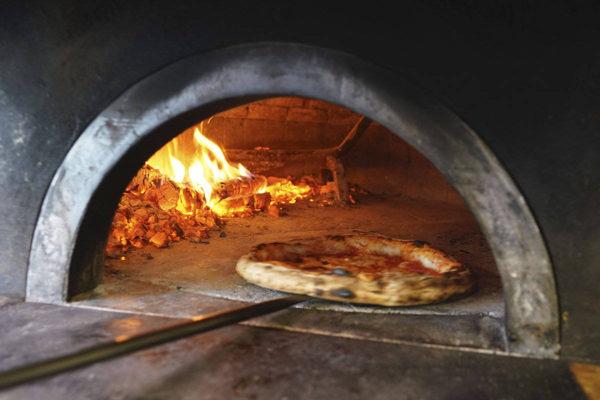 Pizzas are being prepared for home delivery at the Caputo pizzeria in Naples, Monday, April 27, 2020. Region Campania allowed cafes and pizzerias to reopen for delivery Monday, after a long precautionary closure due to the coronavirus outbreak. (AP Photo/Andrew Medichini)