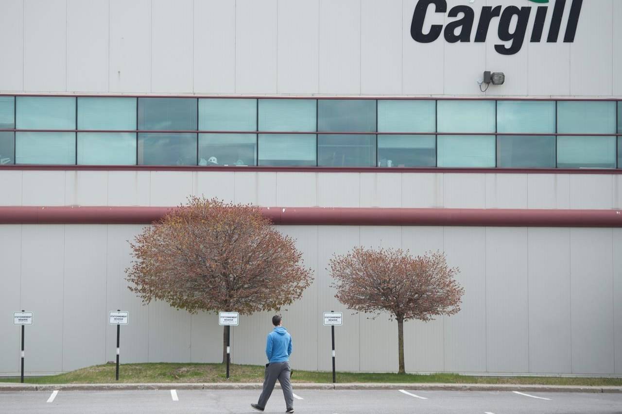 A man walks into a Cargill meat processing factory in Chambly, Que., south of Montreal, Sunday, May 10, 2020. THE CANADIAN PRESS/Graham Hughes