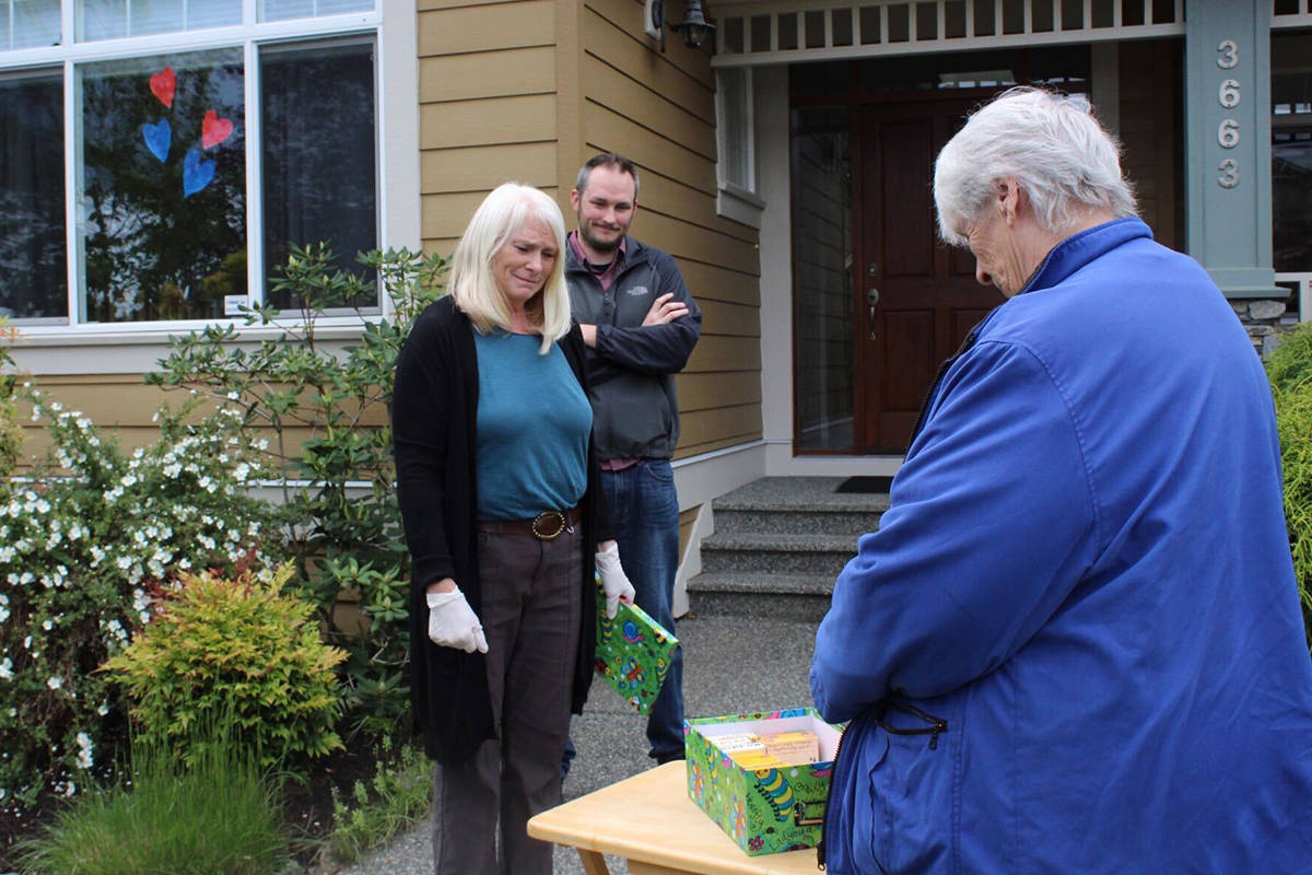 Wendy Robinson and Chris Wallinger look on as the tapes are returned to Marion Baker. (Greg Sakaki/Black Press)