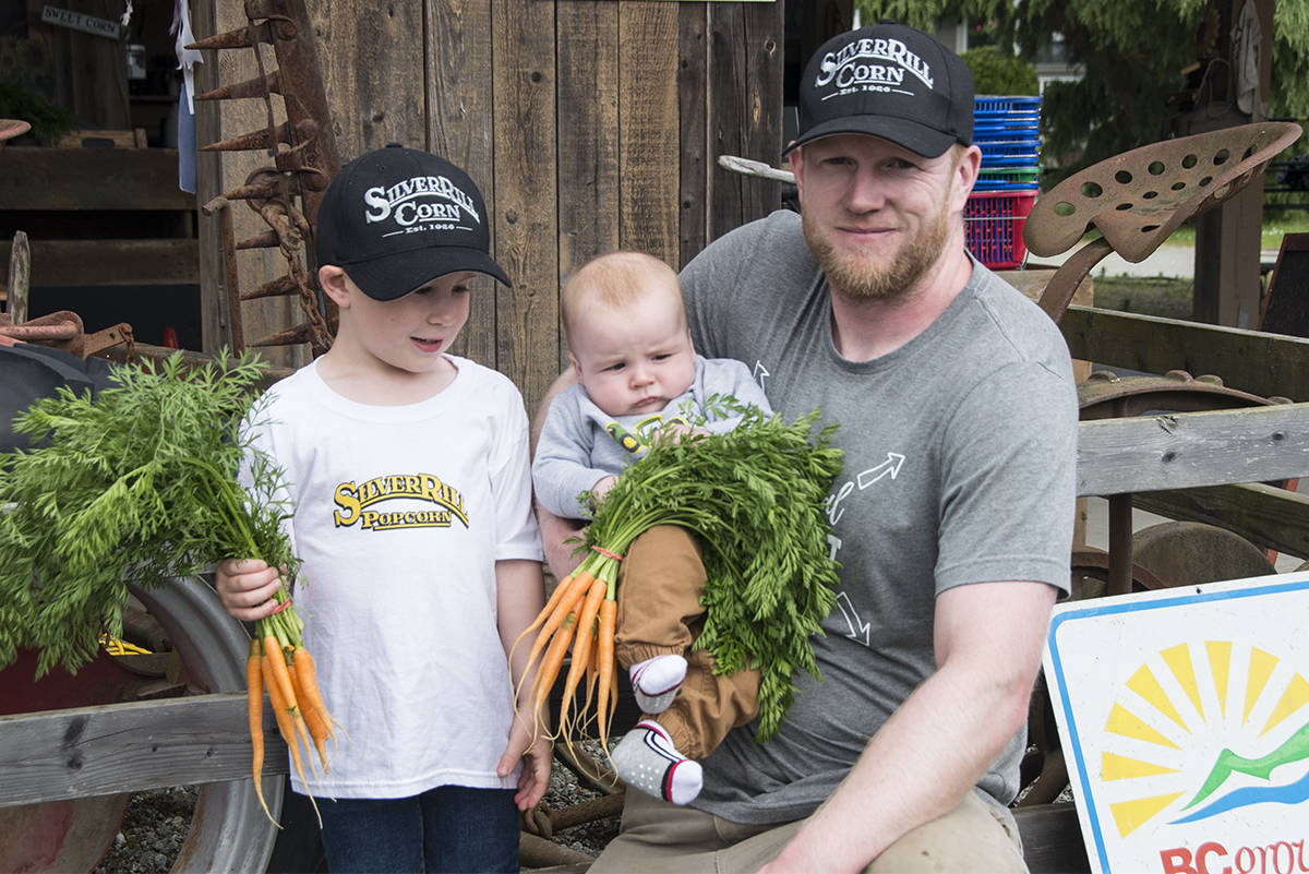 Clayton Fox (right) co-owner of Silver Rill Corn with sons Paxton (left) and baby Colton. Silver Rill Corn opened its roadside market on May 25. (Nina Grossman/News Staff)