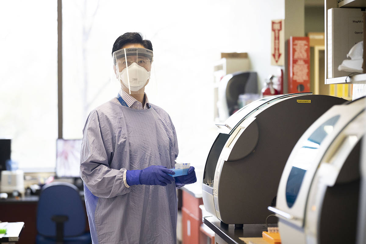 Medical Laboratory Technologist, Nai Jun Zhu working in a VCH lab.
