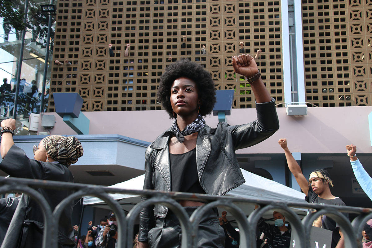 Pam Buisa, one of the oragnziers behind Sunday’s event, lifts her first in solidarity with the Black Lives Matter movement.