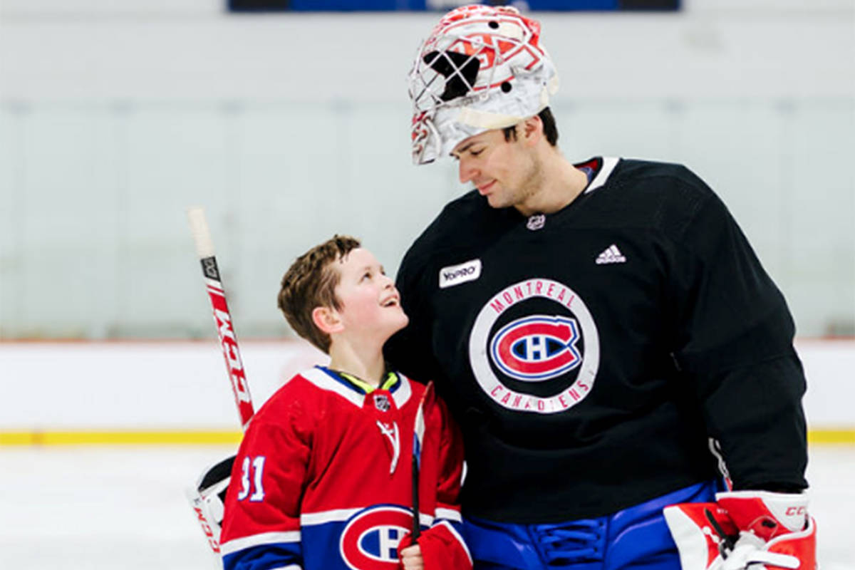 Williams Lake’s Trey Felker looks up at Anahim Lake’s Carey Price during a visit to the team’s practice facility in Montreal earlier this spring. Felker was afforded the trip after being selected as one of three winners of the Breakfast Club of Canada and the Air Canada Foundation’s Shooting for the Stars program. (Marï Photographe)