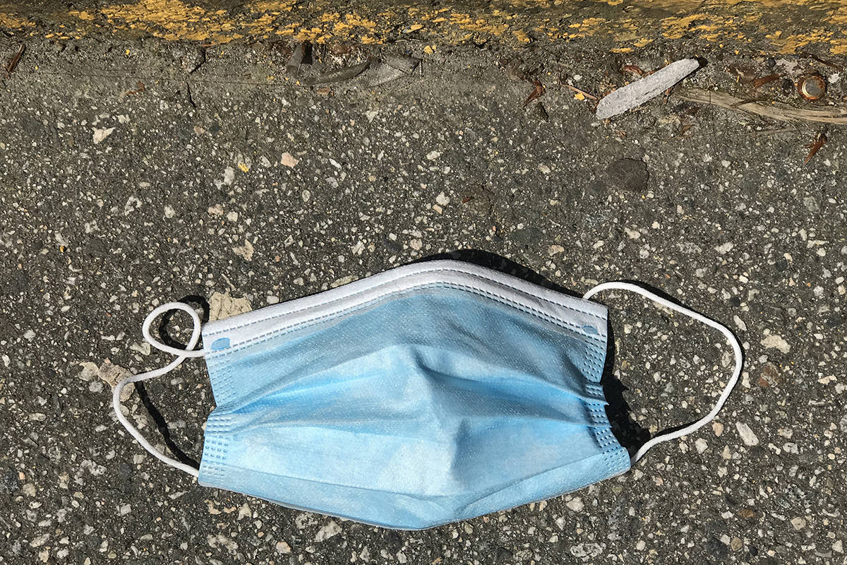 A used protective face mask is seen discarded on the ground in Vancouver, B.C. in May 2020. Protective face masks along with other personal protective equipment have become the new litter being found on the ground during the COVID-19 pandemic. THE CANADIAN PRESS/Jonathan Hayward