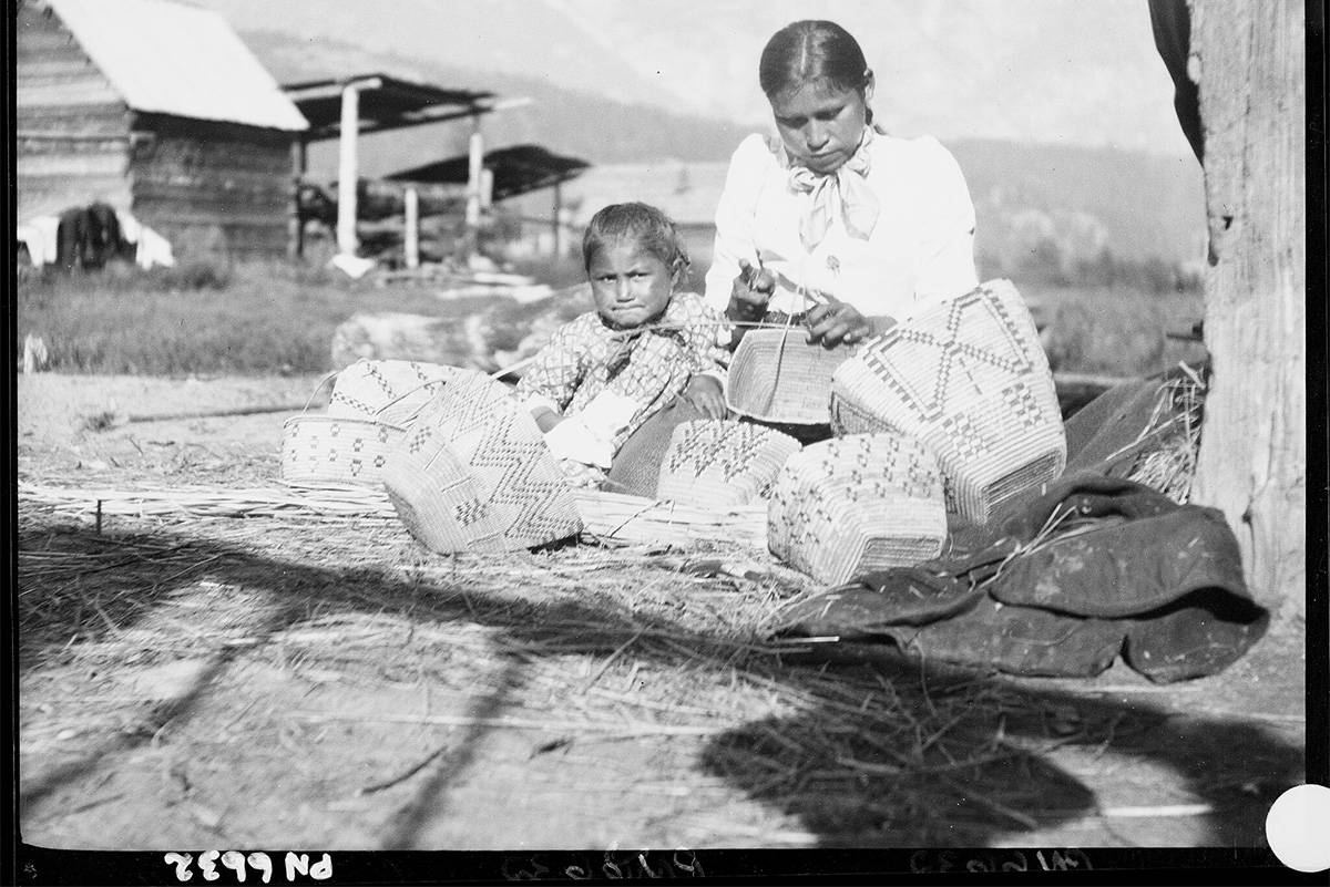 An image from the Royal BC Museum’s digitized collection of historical photographs shows an Interior Salish woman and child weaving baskets. The image is one of thousands posted in an online database. (Courtesy of the Royal BC Museum)