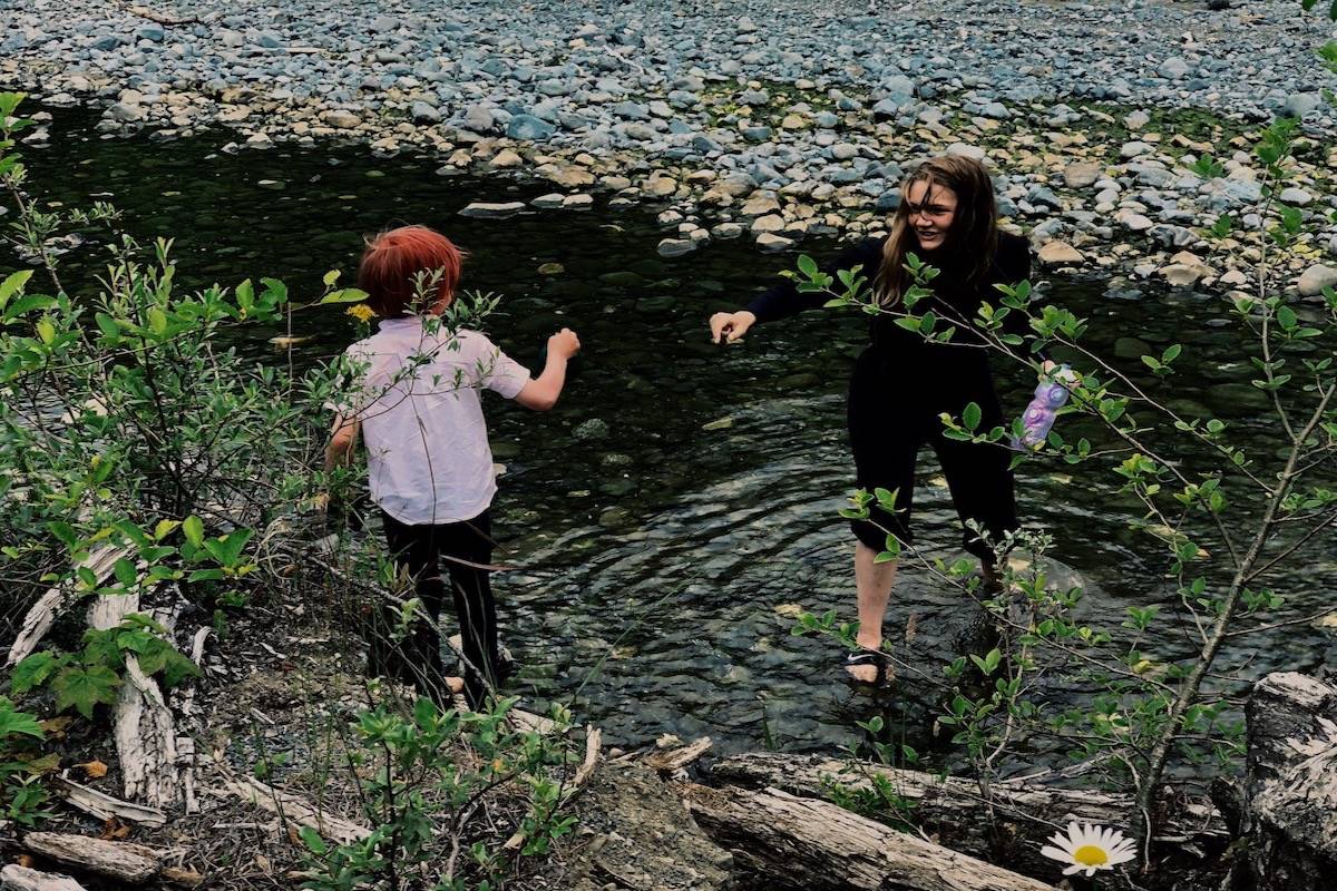 Children play near a stream during an afternoon at a Rainbow Family gathering on North Vancouver Island. Photo by Binny Paul/Campbell River Mirror