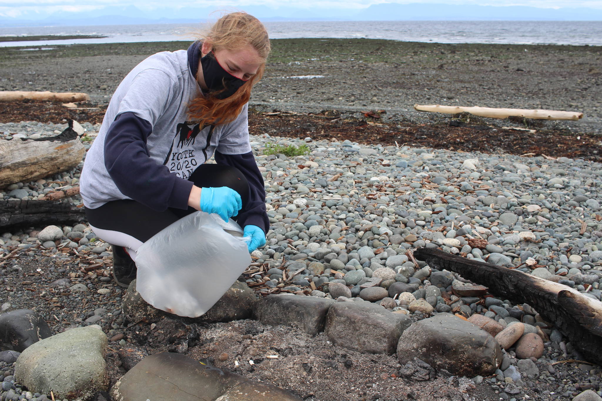 Volunteer Katie Crombie picks up a cigarette butt at Ken Forde Park on July 8. Photo by Marc Kitteringham, Campbell River Mirror