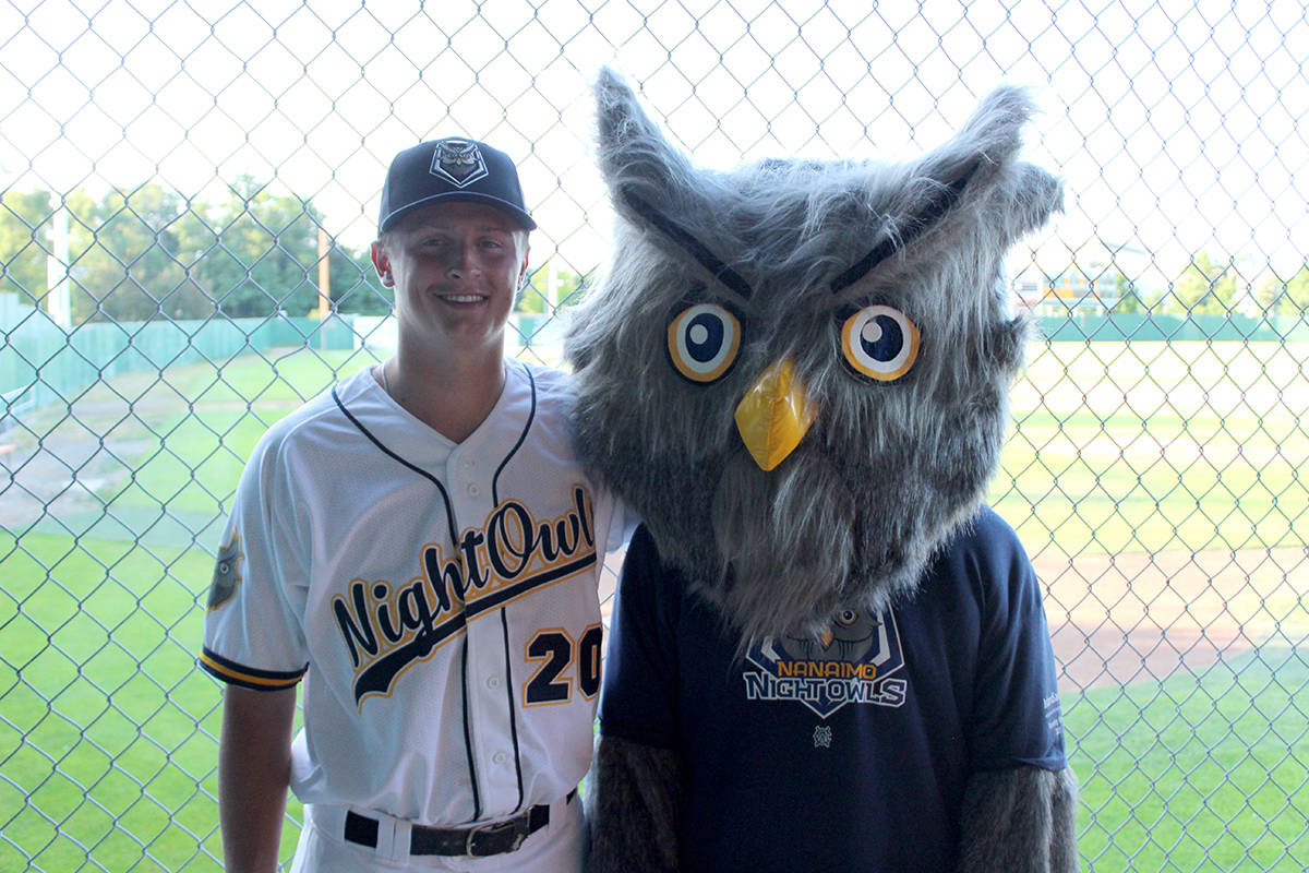 Nanaimo baseball player Josh Laukkanen, who played in the West Coast League last summer, models the Nanaimo NightOwls’ new home uniform, as Ney-te the NightOwl also gets in the picture. (Greg Sakaki/News Bulletin)
