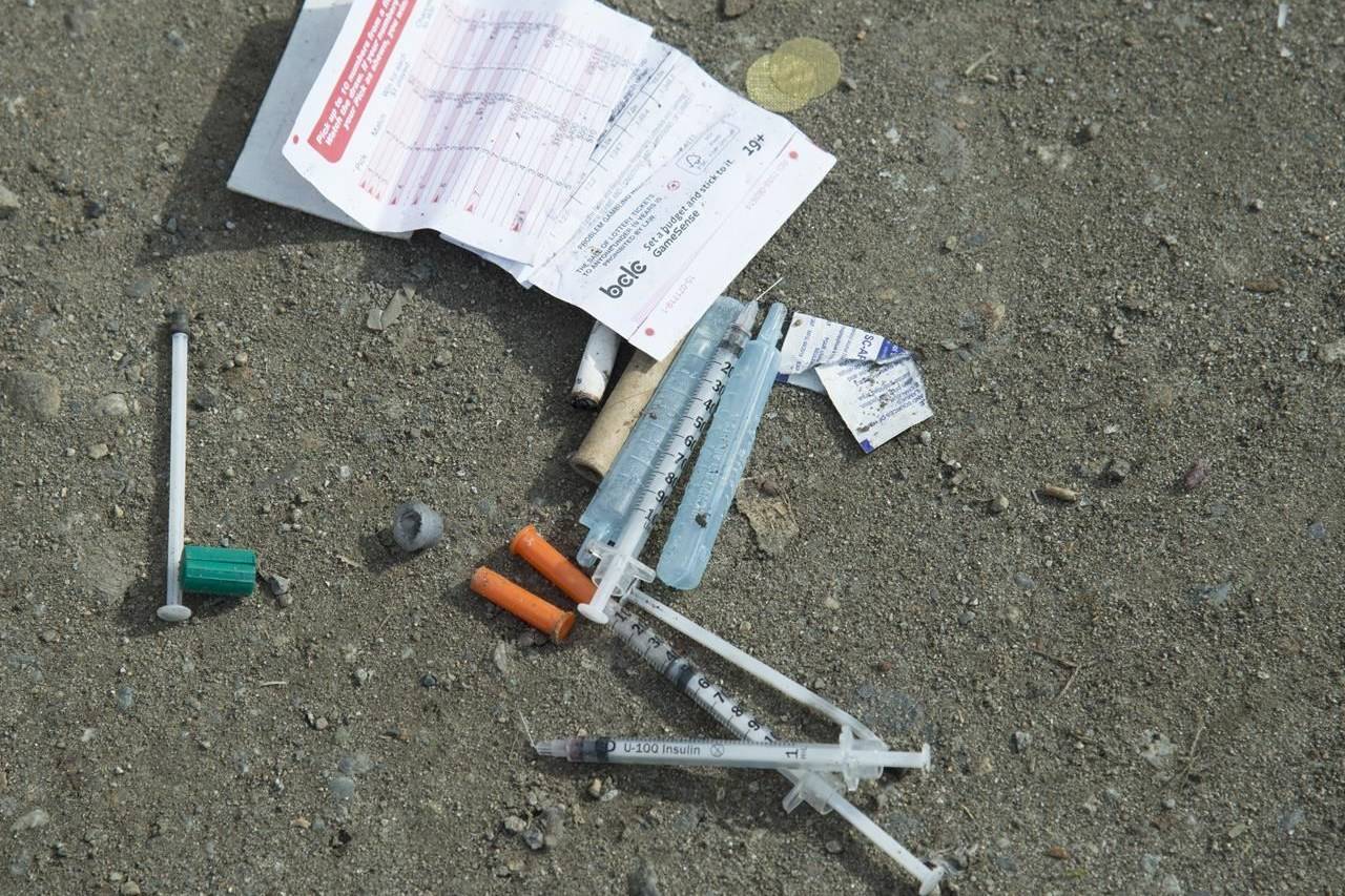 Needles are seen on the ground in Oppenheimer park in Vancouver’s downtown eastside on March 17, 2020. Indigenous and civil liberties groups say the British Columbia government failed to consult them before proposing legislation that would force youth under 19 to stay in hospital after an overdose. THE CANADIAN PRESS/Jonathan Hayward