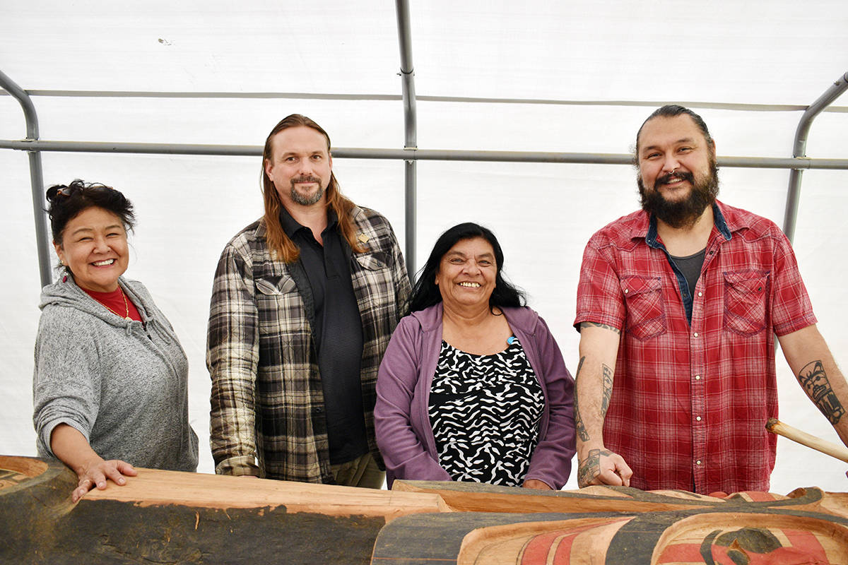 A memorial totem pole in honour of missing and murdered Indigenous women will be raised in September. Organizers Arlene Roberts, Marc Snelling and Gladys Radek along with carver Mike Dangeli are seen here with the partially-finished pole under a tent in Dangeli’s back yard on Terrace’s Southside July 16, 2020. (Jake Wray/Terrace Standard)