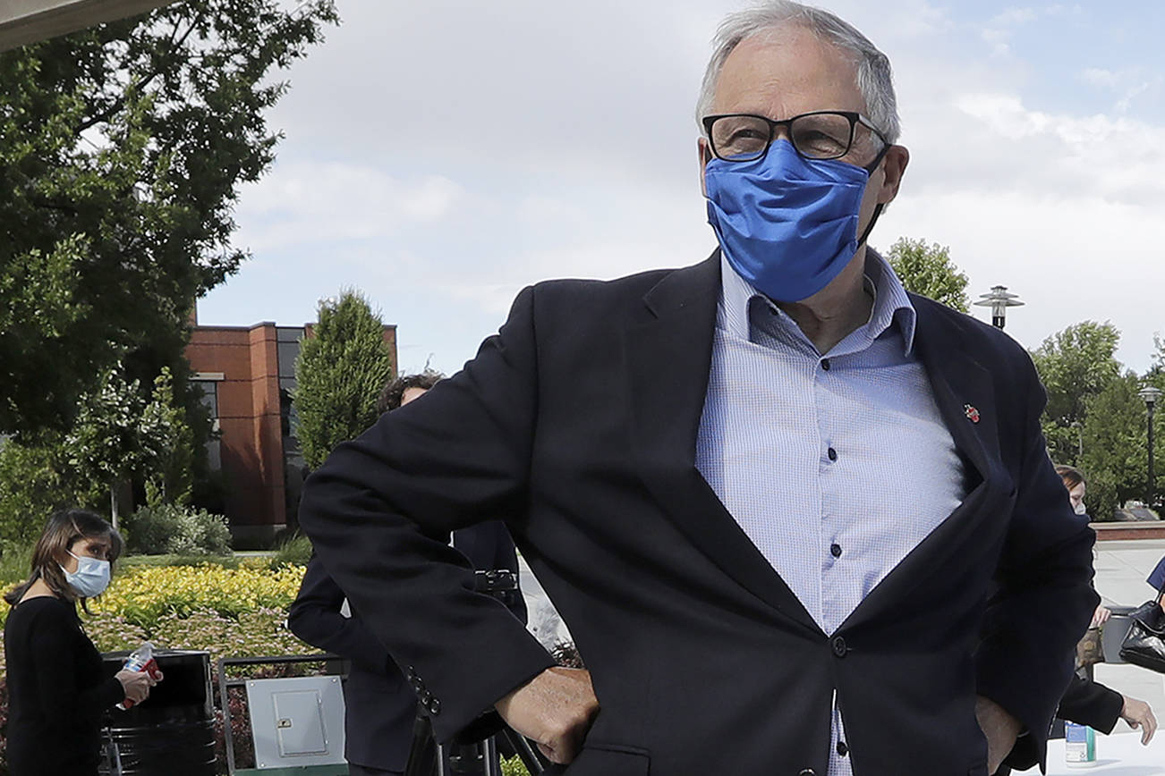 In this photo taken Tuesday, June 16, 2020, Washington state Gov. Jay Inslee talks about the coronavirus outbreak following a briefing at Yakima Valley College in Yakima, Wash. (AP Photo/Elaine Thompson)