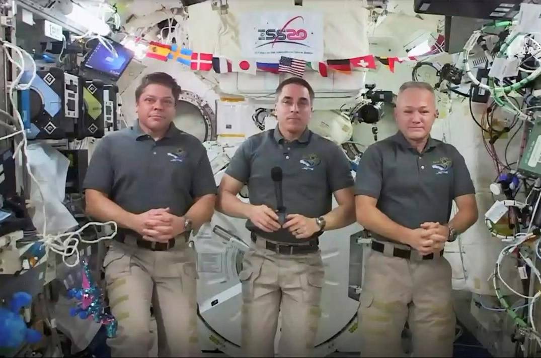 This photo provided by NASA shows from left, astronauts Bob Behnken, Chris Cassidy and Doug Hurley during an interview on the International Space Station on Friday, July 31, 2020. Behnken and Hurley are scheduled to leave the International Space Station in a SpaceX capsule on Saturday and splashdown off the coast of Florida on Sunday. (NASA via AP)