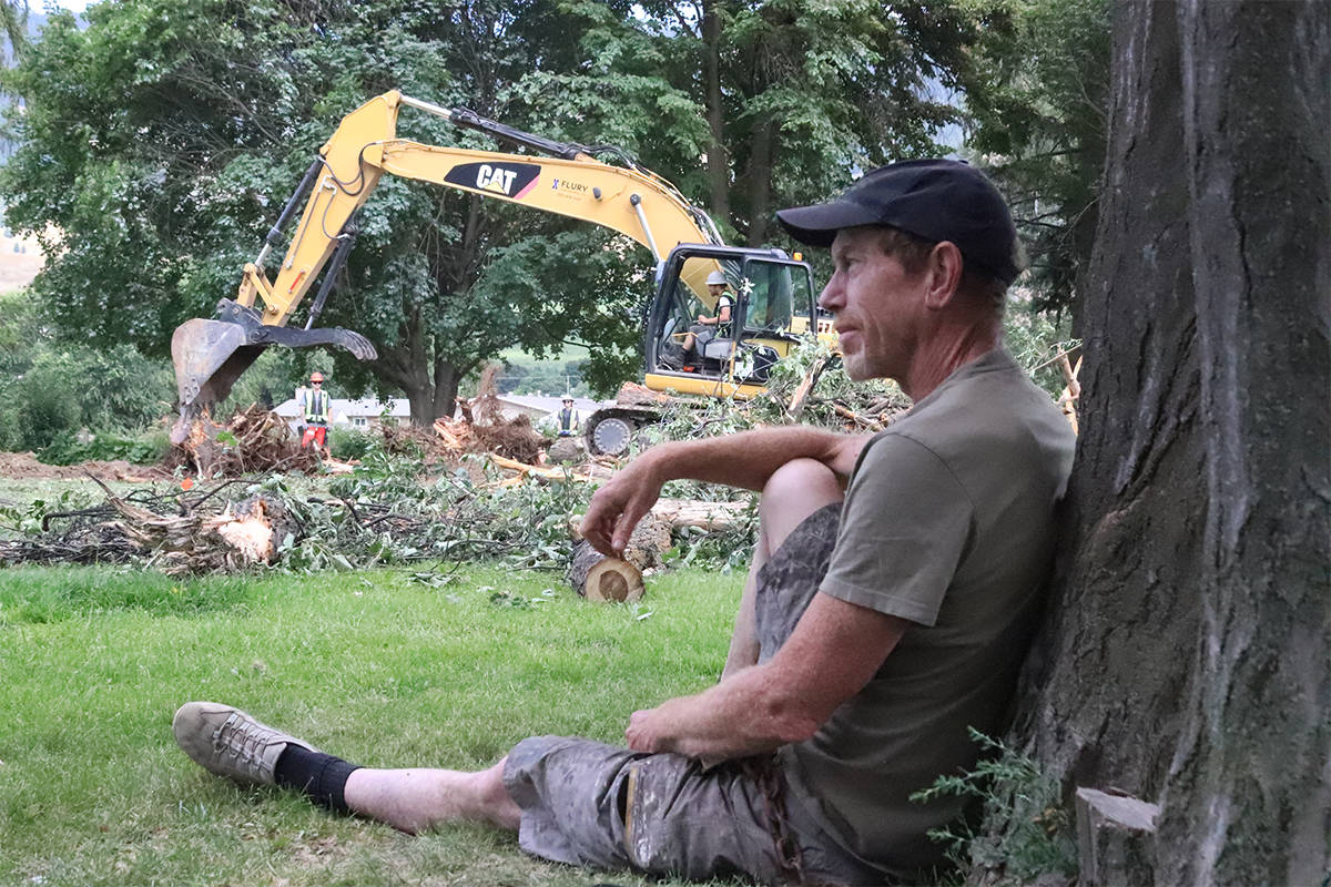 Lavington resident Dave Pope chained himself to a tree in the park across from the local elementary school Thursday, Aug. 6, 2020, in protest against use of park space for the construction of a child care facility. (Brendan Shykora - Morning Star)                                Lavington resident Dave Pope chained himself to a tree in the park across from the local elementary school Thursday, Aug. 6, 2020, in protest against use of park space for the construction of a child care facility. (Brendan Shykora - Morning Star)