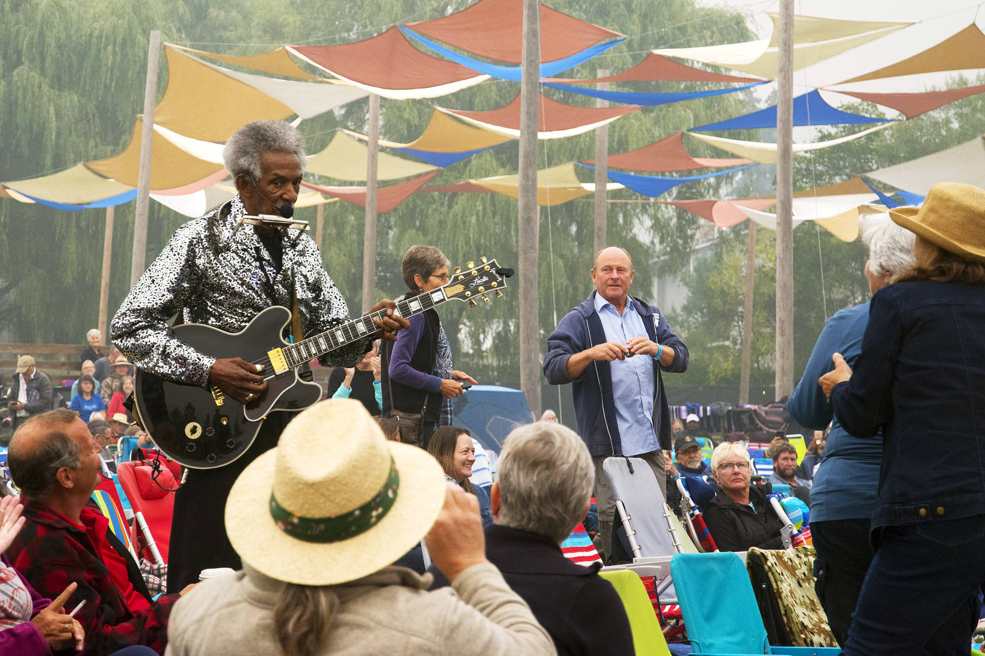 Lil Jimmy Reed keeps up the tune on guitar and harmonica after climbing down from the Roots & Blues main stage to walk amongst the crowd during the 2018 festival. Reed will be one of the performers featured in the online 2020 festival’s first night. (Jim Elliot/Salmon Arm Observer)